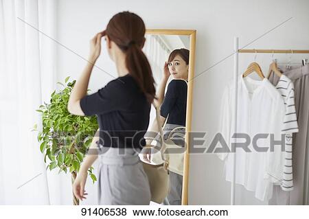 Young Japanese woman at home getting ready in the morning View Large Photo Image Stock Photo - Young Japanese woman at home getting ready in the morning. Fotosearch