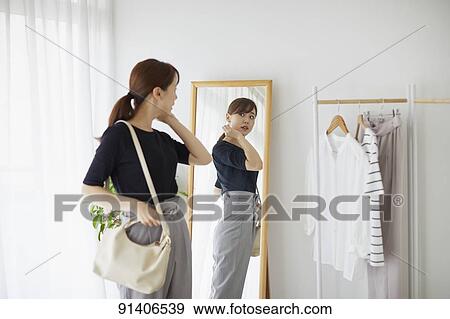 Young Japanese woman at home getting ready in the morning View Large Photo Image Stock Photo - Young Japanese woman at home getting ready in the morning. Fotosearch