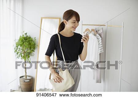 Young Japanese woman at home getting ready in the morning View Large Photo Image Stock Photo - Young Japanese woman at home getting ready in the morning. Fotosearch