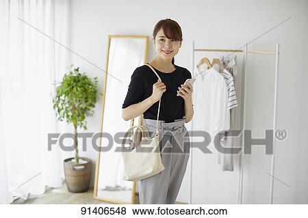 Young Japanese woman at home getting ready in the morning View Large Photo Image Stock Photo - Young Japanese woman at home getting ready in the morning. Fotosearch