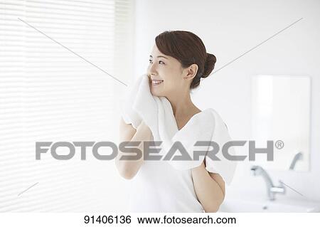 Stock Photograph - Young Japanese woman at home getting ready in the morning. Fotosearch