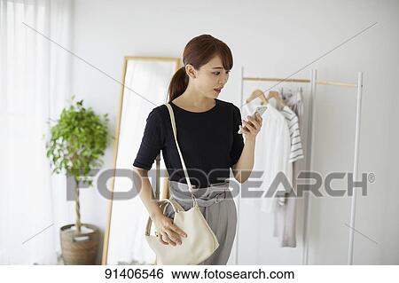 Young Japanese woman at home getting ready in the morning View Large Photo Image Stock Photograph - Young Japanese woman at home getting ready in the morning. Fotosearch