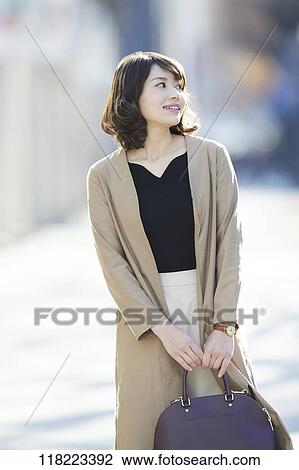 Young Japanese woman downtown Tokyo View Large Photo Image Stock Image - Young Japanese woman downtown Tokyo. Fotosearch