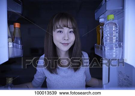 Young Japanese woman eating night snack from the fridge View Large Photo Image Stock Photo - Young Japanese woman eating night snack from the fridge. Fotosearch