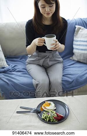 Young Japanese woman having breakfast at home View Large Photo Image Picture - Young Japanese woman having breakfast at home. Fotosearch