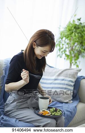 Young Japanese woman having breakfast at home View Large Photo Image Picture - Young Japanese woman having breakfast at home. Fotosearch