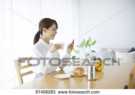 Young Japanese woman having breakfast at home View Large Photo Image Stock Image - Young Japanese woman having breakfast at home. Fotosearch