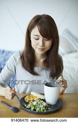 Young Japanese woman having breakfast at home View Large Photo Image Stock Image - Young Japanese woman having breakfast at home. Fotosearch