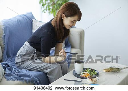 Young Japanese woman having breakfast at home View Large Photo Image Stock Image - Young Japanese woman having breakfast at home. Fotosearch