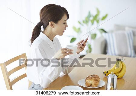 Young Japanese woman having breakfast at home View Large Photo Image Stock Photo - Young Japanese woman having breakfast at home. Fotosearch