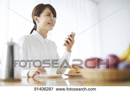 Young Japanese woman having breakfast at home View Large Photo Image Stock Photo - Young Japanese woman having breakfast at home. Fotosearch