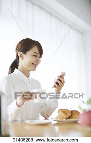 Young Japanese woman having breakfast at home View Large Photo Image Stock Photo - Young Japanese woman having breakfast at home. Fotosearch
