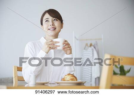 Young Japanese woman having breakfast at home View Large Photo Image Stock Photo - Young Japanese woman having breakfast at home. Fotosearch