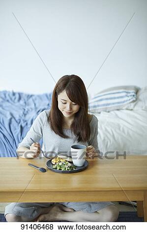 Young Japanese woman having breakfast at home View Large Photo Image Stock Photo - Young Japanese woman having breakfast at home. Fotosearch