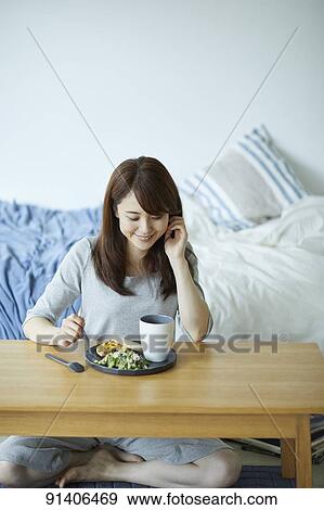 Young Japanese woman having breakfast at home View Large Photo Image Stock Photo - Young Japanese woman having breakfast at home. Fotosearch