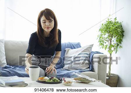 Young Japanese woman having breakfast at home View Large Photo Image Stock Photo - Young Japanese woman having breakfast at home. Fotosearch
