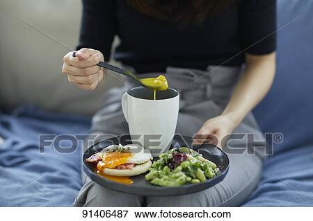 Young Japanese woman having breakfast at home View Large Photo Image Stock Photo - Young Japanese woman having breakfast at home. Fotosearch