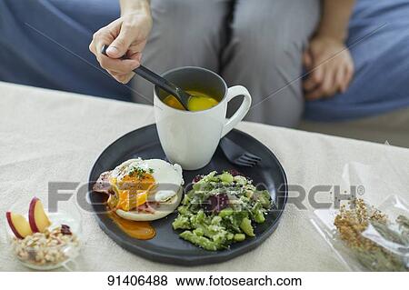 Young Japanese woman having breakfast at home View Large Photo Image Stock Photo - Young Japanese woman having breakfast at home. Fotosearch
