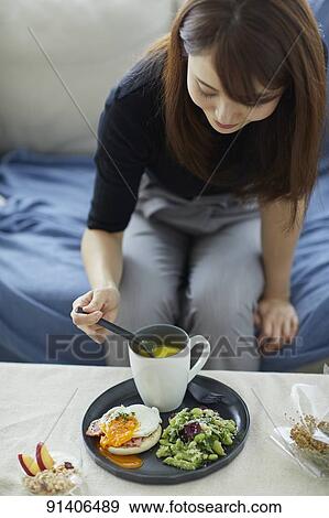 Young Japanese woman having breakfast at home View Large Photo Image Stock Photo - Young Japanese woman having breakfast at home. Fotosearch