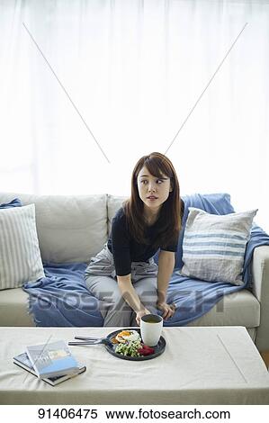 Young Japanese woman having breakfast at home View Large Photo Image Stock Photography - Young Japanese woman having breakfast at home. Fotosearch