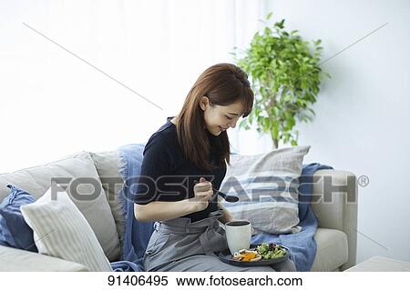 Young Japanese woman having breakfast at home View Large Photo Image Stock Photography - Young Japanese woman having breakfast at home. Fotosearch