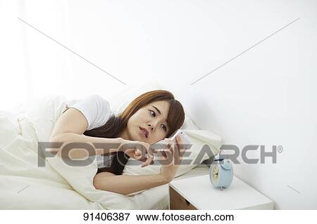 Young Japanese woman in bed in the morning View Large Photo Image Stock Photo - Young Japanese woman in bed in the morning. Fotosearch