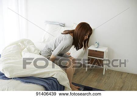 Stock Photo - Young Japanese woman in bed in the morning. Fotosearch
