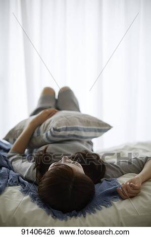 Young Japanese woman in bed in the morning View Large Photo Image Stock Photograph - Young Japanese woman in bed in the morning. Fotosearch