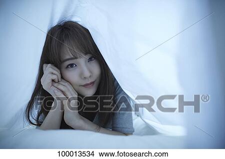 Young Japanese woman in bed View Large Photo Image Picture - Young Japanese woman in bed. Fotosearch