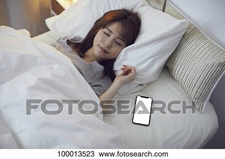 Young Japanese woman in bed View Large Photo Image Stock Image - Young Japanese woman in bed. Fotosearch