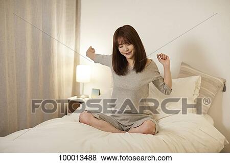 Young Japanese woman in bed View Large Photo Image Stock Photo - Young Japanese woman in bed. Fotosearch