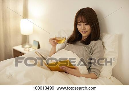 Young Japanese woman in bed View Large Photo Image Stock Photo - Young Japanese woman in bed. Fotosearch