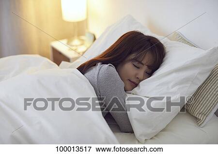 Young Japanese woman in bed View Large Photo Image Stock Photo - Young Japanese woman in bed. Fotosearch