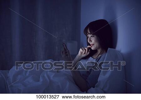 Young Japanese woman in bed View Large Photo Image Stock Photo - Young Japanese woman in bed. Fotosearch