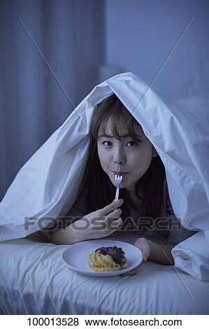 Young Japanese woman in bed View Large Photo Image Stock Photo - Young Japanese woman in bed. Fotosearch