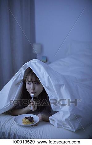 Young Japanese woman in bed View Large Photo Image Stock Photo - Young Japanese woman in bed. Fotosearch