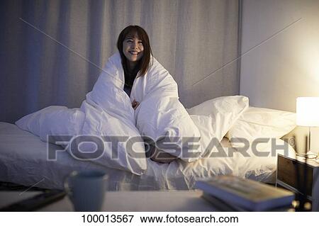 Young Japanese woman in bed View Large Photo Image Stock Photo - Young Japanese woman in bed. Fotosearch