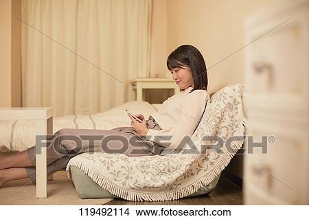 Young Japanese woman in her house View Large Photo Image Picture - Young Japanese woman in her house. Fotosearch