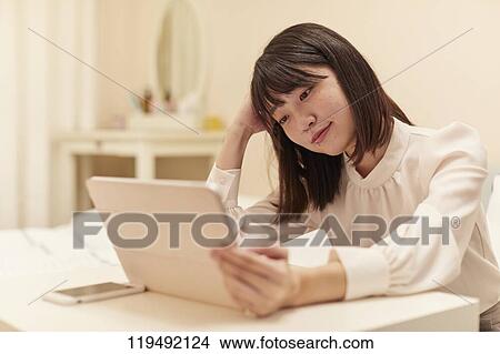 Young Japanese woman in her house View Large Photo Image Picture - Young Japanese woman in her house. Fotosearch