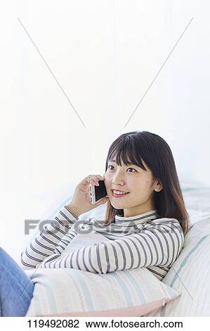 Young Japanese woman in her house View Large Photo Image Stock Image - Young Japanese woman in her house. Fotosearch