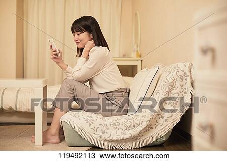 Young Japanese woman in her house View Large Photo Image Stock Image - Young Japanese woman in her house. Fotosearch