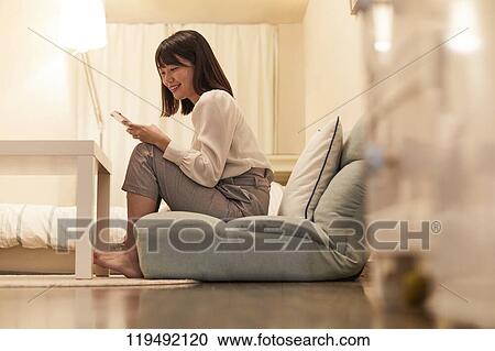 Young Japanese woman in her house View Large Photo Image Stock Image - Young Japanese woman in her house. Fotosearch