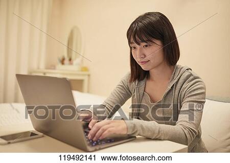 Young Japanese woman in her house View Large Photo Image Stock Image - Young Japanese woman in her house. Fotosearch