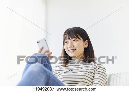 Young Japanese woman in her house View Large Photo Image Stock Photo - Young Japanese woman in her house. Fotosearch