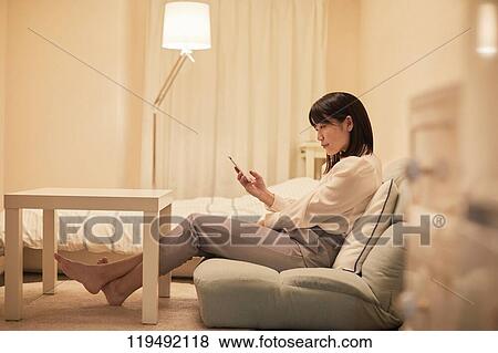 Stock Photo - Young Japanese woman in her house. Fotosearch