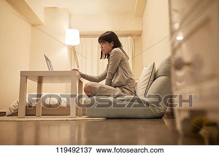 Young Japanese woman in her house View Large Photo Image Stock Photo - Young Japanese woman in her house. Fotosearch