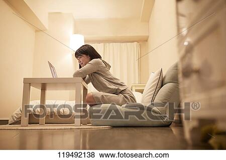 Stock Photo - Young Japanese woman in her house. Fotosearch