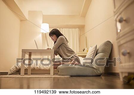 Young Japanese woman in her house View Large Photo Image Stock Photo - Young Japanese woman in her house. Fotosearch
