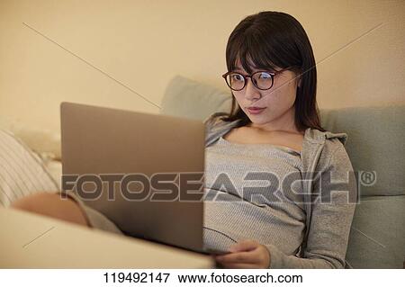 Stock Photo - Young Japanese woman in her house. Fotosearch