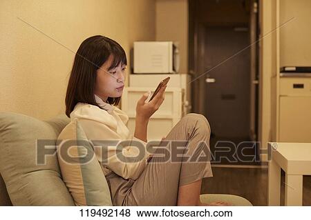Young Japanese woman in her house View Large Photo Image Stock Photo - Young Japanese woman in her house. Fotosearch